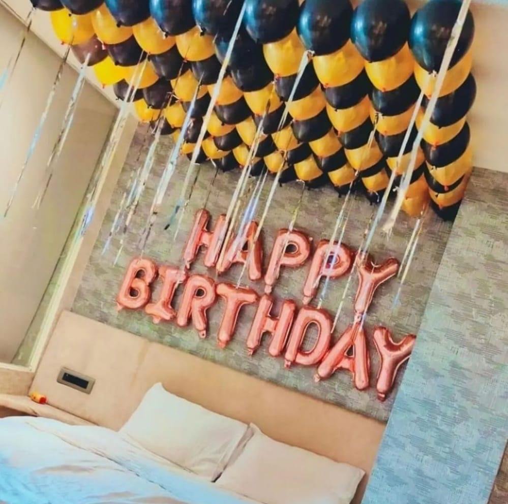Black and gold ceiling balloon decoration with Happy Birthday foil balloons